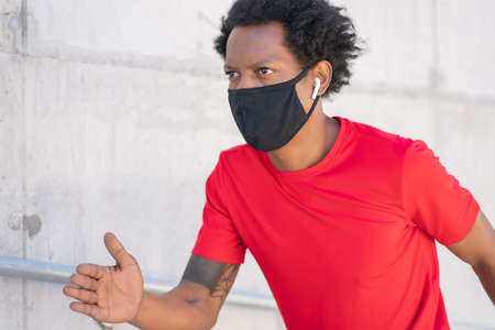 Athletic man running and doing exercise outdoors.の写真素材