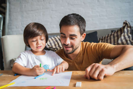 Father and son playing together at home.の写真素材