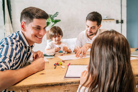 Gay couple spending good time together with their daughter and son.の写真素材