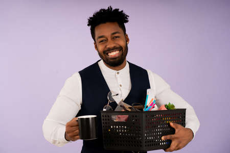 Businessman holding a box with personal items for the office,の写真素材