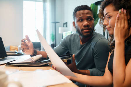 Young couple planning monthly budget together.の写真素材