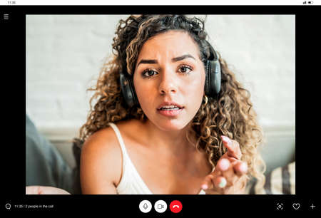 Young business woman on a work video call while staying at home.の写真素材