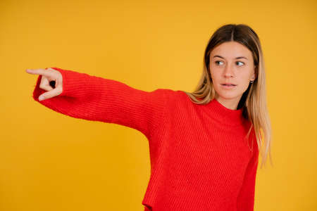 Young woman pointing something with her finger.の写真素材