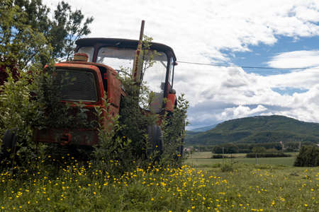 Rusted and retro Tractor, abandoned in the nature. France, Drome Provencal