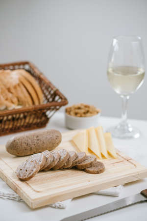 Pork cheese on table with cheeses and white wineの写真素材