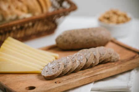 Pork cheese on table with cheeses and white wine