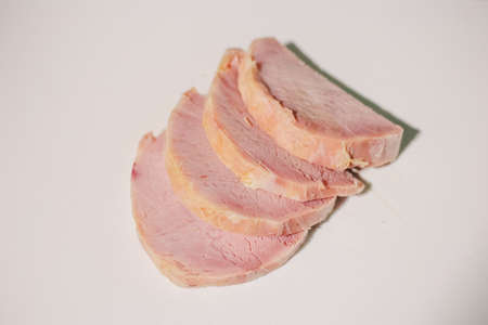 tenderloin cooked in pieces and slices on the boardの写真素材