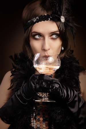 Portrait of a flapper girl at a party drinking champagne Portrait of a flapper girl at a party drinking champagne