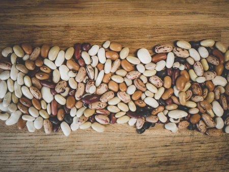 different beans spred on wood board, perfect for backgroundの写真素材