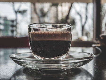 isolated glass coffee cup, dark espresso with foam