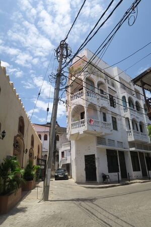 Mombasa, Kenya - September 17, 2017: Scene on the street with a beautiful white building and electric wires in front of blue skyのeditorial素材