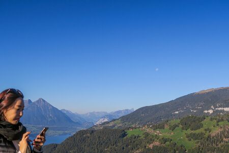 View over the city of Interlaken, the alps, mountains, lakes, moon, tourists photographingのeditorial素材