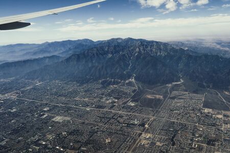Mountain and canyon view, clouds and blue sky above Arizona, Utah and Colorado during the flight to LAの写真素材