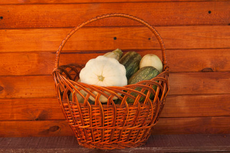 a basket of zucchini on wooden backgroundの写真素材
