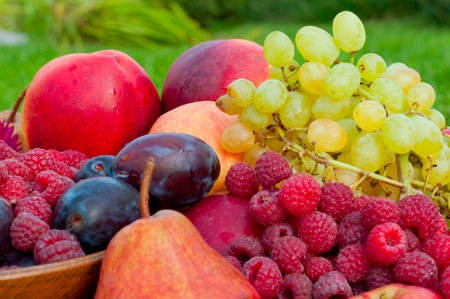 different types of fruit and raspberry closeup with flower asterの写真素材