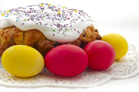 Easter cake with colored eggs on a white background
