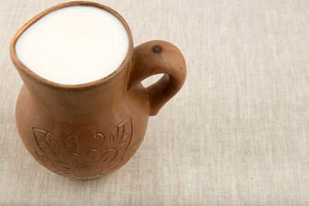 clay jug with milk  on the background of natural linen tableclothsの写真素材
