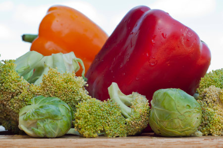 red and yellow peppers, brussels sprouts with broccoli on a white backgroundの写真素材