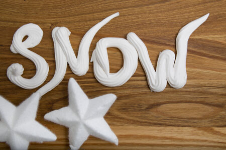 Snow whipped cream inscription on the boardの写真素材