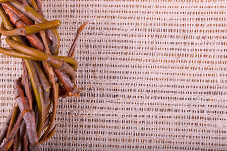 wreath of willow branches on the texture of linen fabric closeupの写真素材