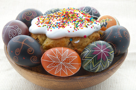 Easter cake with colored eggs on a white background