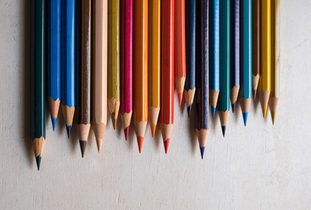 Colour pencils isolated on white wood background close upの写真素材