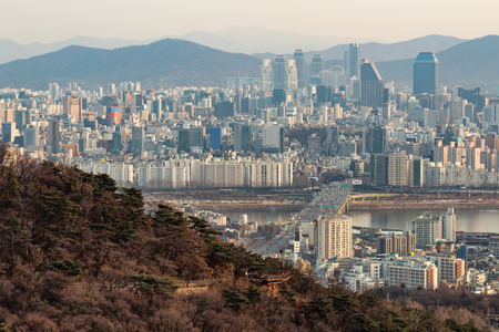 SEOUL, SOUTH KOREA - JAN 22, 2018: Aerial shot of Seoul skyline from Namsan Park with highway and river at sunset polluted airのeditorial素材