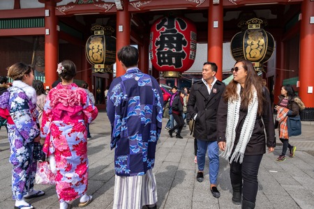 TOKYO, JAPAN - 13 FEB 2018: Tourists and locals dressed with kimonos walking in Senso-ji temple looking at the giant lanternのeditorial素材