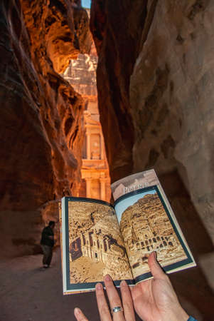 Having a look at the brochure of Petra from the Siq, The treasury can be seen at the end of the canyonの写真素材