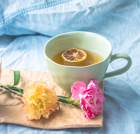 Carnation with a cup of afternoon tea on the tableの写真素材