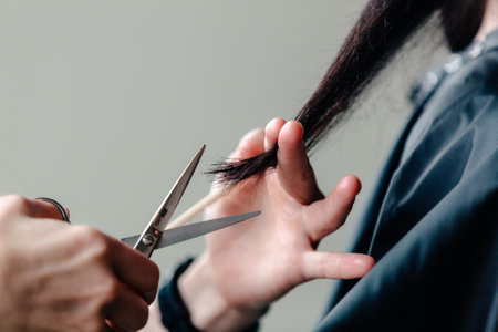 a stylist cuts hair a woman long hairの写真素材