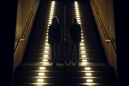 pals stand on lit steps
