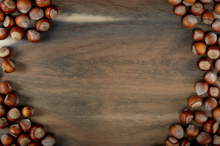 top view of hazelnuts in shell on wooden background with copy space