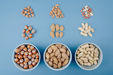 top view of mixed nuts in shell and without shell on blue backgroundの写真素材