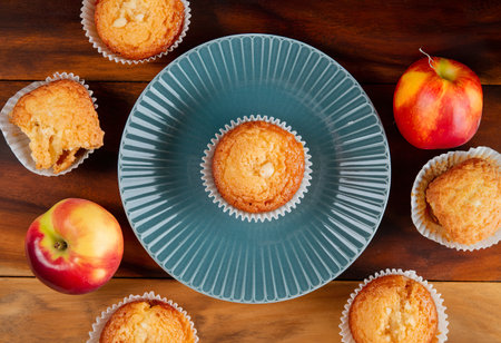 top view of peach jam cupcake with plate on center on wooden backgroundの写真素材
