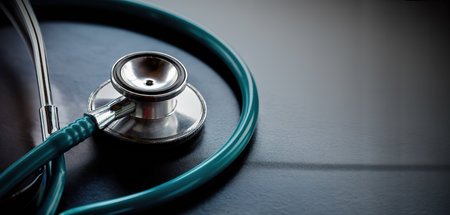 Stethoscope on a glass table, dark background, The concept of medicine and medical treatment