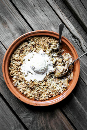 Homemade apple crumble vanilla ice cream on wooden tableの写真素材