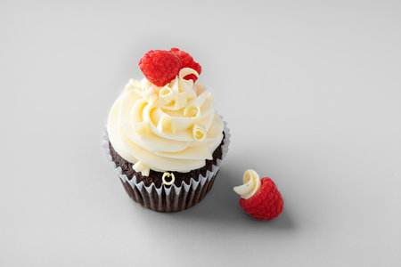 Chocolate cupcakes with white chocolate frosting and fresh raspberries