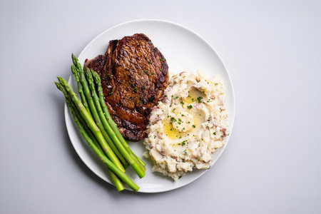 Traditional steak and mashed potatoes with blanched asparagusの写真素材