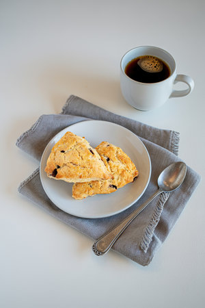 Homemade chocolate chunk scones with coffee for breakfastの写真素材