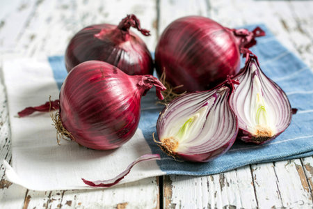 Red onions on a old white wooden tableの写真素材