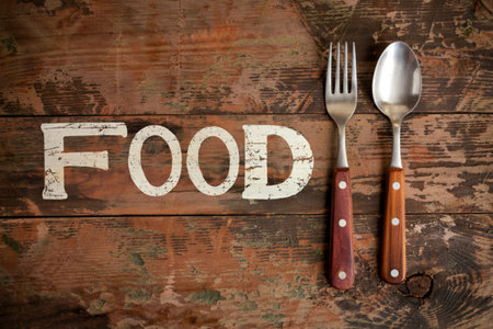 Fork and spoon on grunge wood food background concept ,menu design and advertising campaignの写真素材