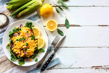 top view of corn salad and lemon on cloth and wooden background with copy space