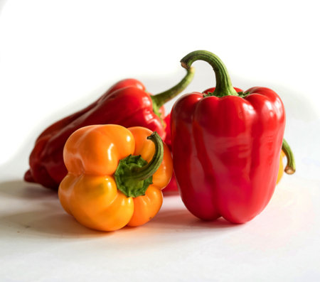 red and yellow sweet peppers isolated on white background