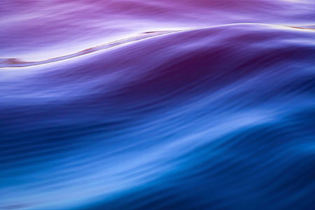 A serene image of calm ocean waves at dusk, captured with a long exposure to create smooth, flowing...