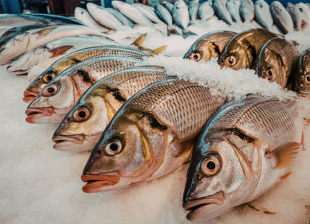 Fresh fish displayed on ice at marketの写真素材