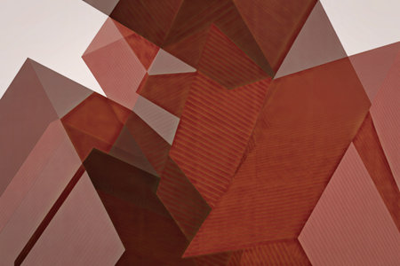 An abstract composition of various red geometric shapes, including triangles and polygons, arranged in a seemingly random pattern against a white background.の写真素材