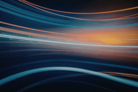 The image features vibrant light trails in shades of blue and orange against a dark background, creating a dynamic visual effect.の写真素材