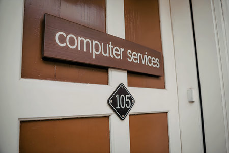 A close-up of a door with a sign that reads 'computer services' and a number '105' on a...