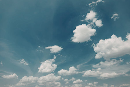 A serene image of a blue sky with white clouds
